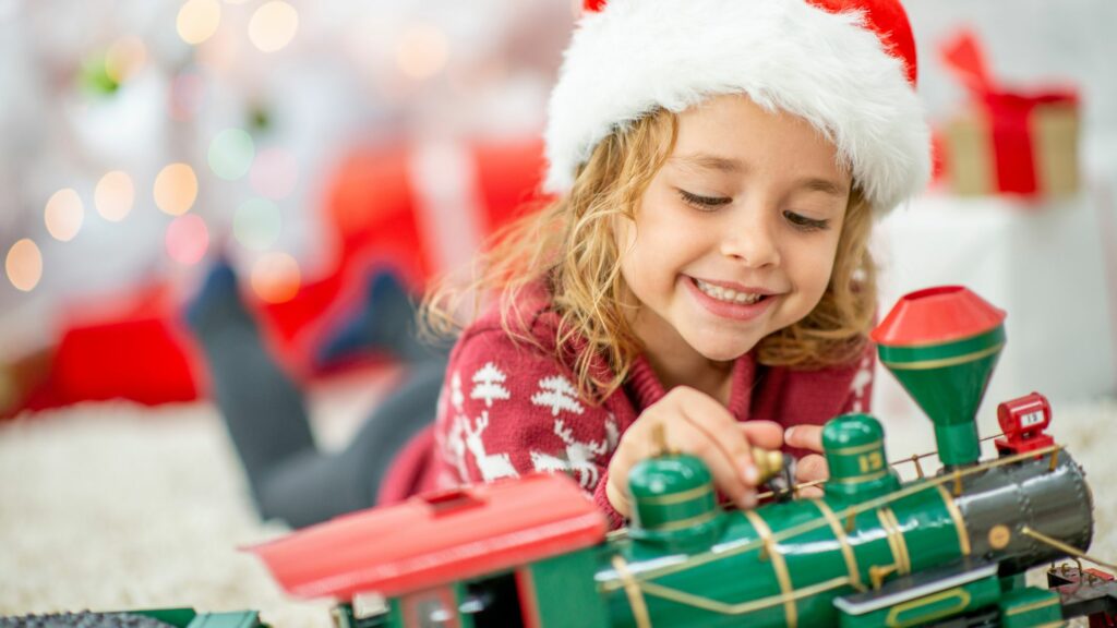 How to support disadvantaged people in your community this christmas child with toy train