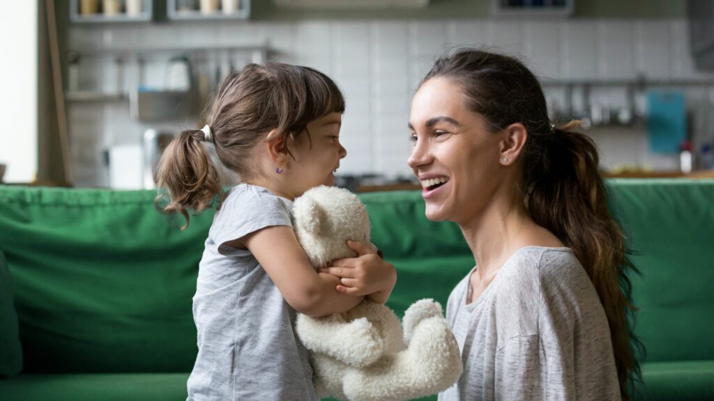 Mum and daughter hugging teddy bear Supporting Underprivileged Children Is Everyone's Responsibility